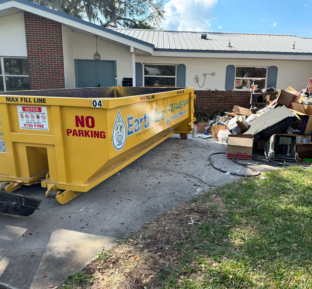 Roll-off dumpster in front of a house during a clean-out in Deltona, FL.