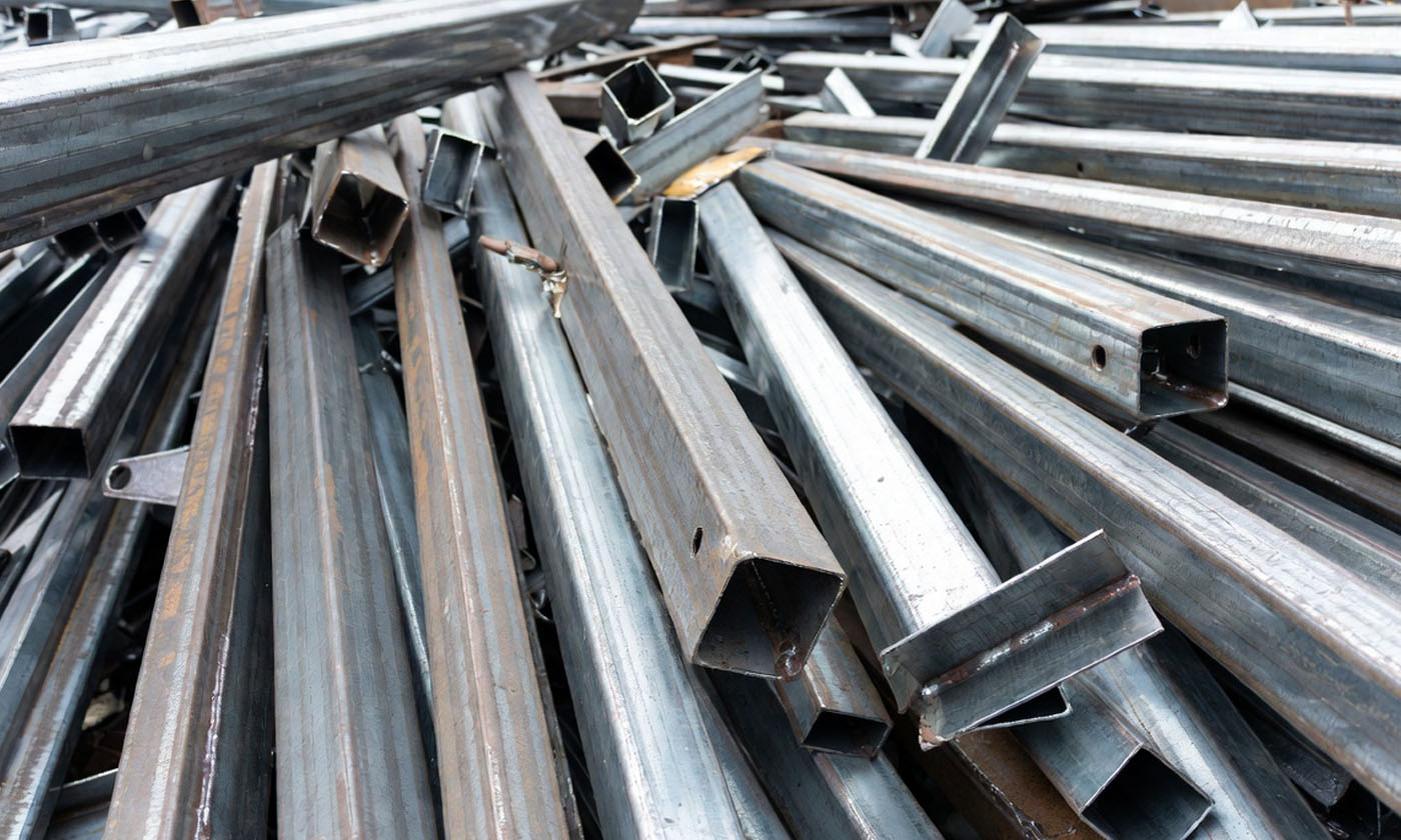 EarthHaul dumpster filled with metal debris at a construction site in Bartow, FL.