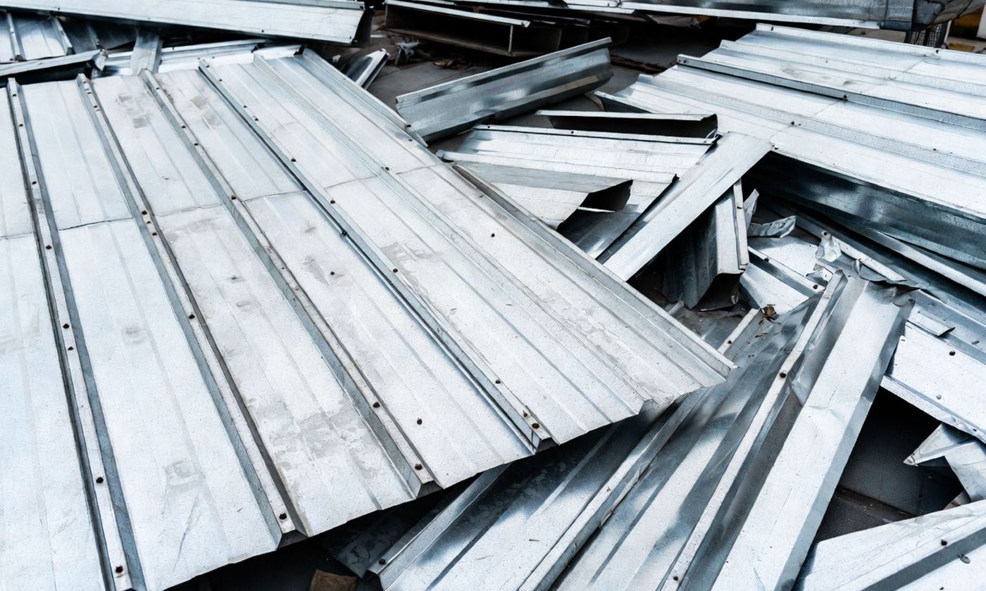 Metal roofing panels and debris in an EarthHaul dumpster in Bartow, FL.
